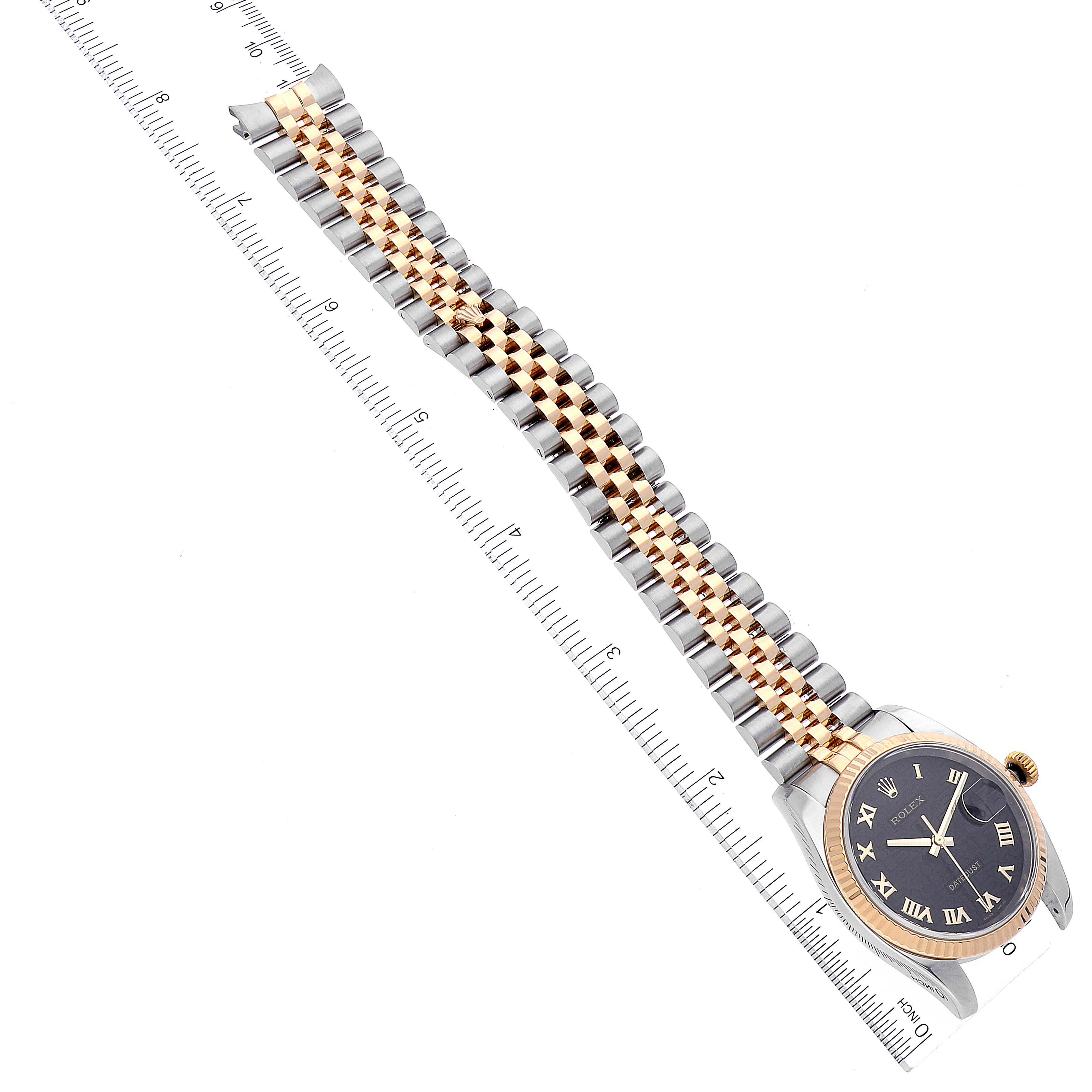 The image shows a Rolex Datejust 116233 Men's Steel and Gold (two tone) Black Dial 116233 Men's Steel and Gold (two tone) Black Dial model watch laying flat, displaying its two-tone bracelet and black dial with a ruler for scale.