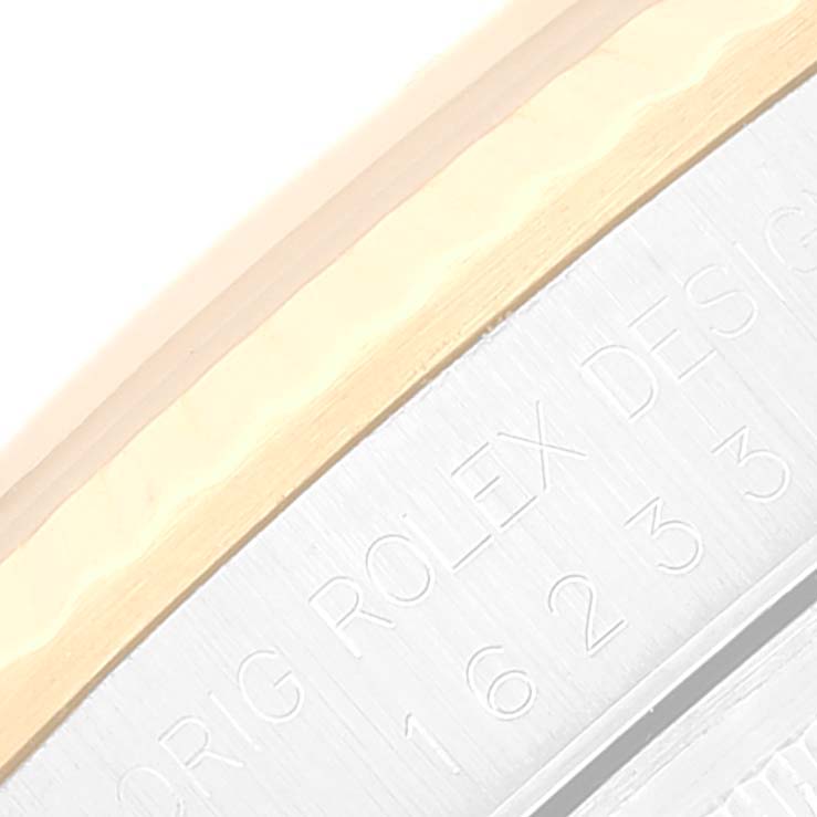 This image shows a close-up angle of the engraved side of the Rolex Datejust 16233 Men's Steel and Gold (two tone) Blue Dial 16233 Men's Steel and Gold (two tone) Blue Dial watch, displaying part of the model number.