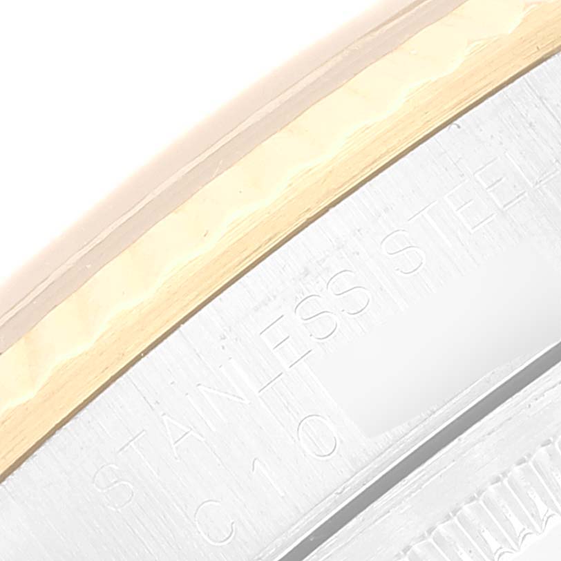 This image shows a close-up of the stainless steel casing and part of the fluted bezel of a Rolex Datejust 16233 Men's Steel and Gold (two tone) Blue Dial 16233 Men's Steel and Gold (two tone) Blue Dial watch.