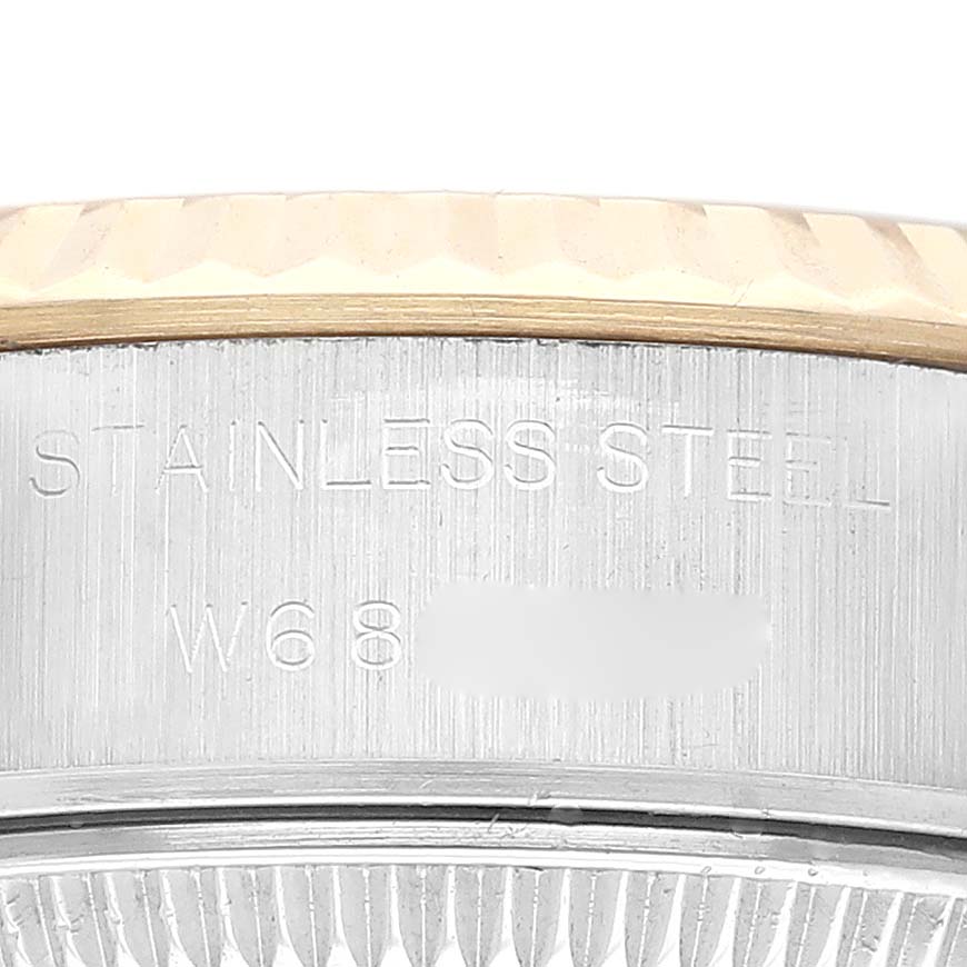 This image shows a close-up of the side of a Rolex Datejust 69173 Women's Steel and Gold (two tone) Champagne Dial 69173 Women's Steel and Gold (two tone) Champagne Dial model watch, highlighting the stainless steel case engraved with text.