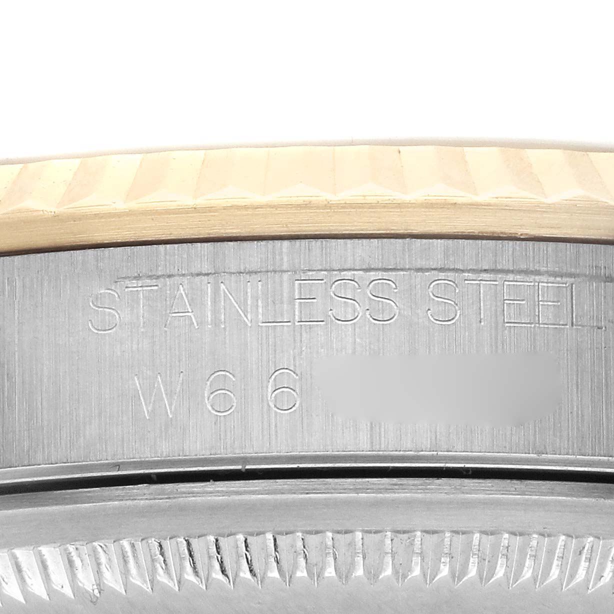 The image shows a close-up of the Rolex Datejust 16233 Men's Steel and Gold (two tone) Champagne Dial 16233 Men's Steel and Gold (two tone) Champagne Dial's side, highlighting the stainless steel marking and part of the bezel.