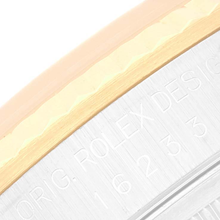 This image shows a close-up of the side of the bezel and case with engravings on a Rolex Datejust 16233 Men's Steel and Gold (two tone) Silver Dial 16233 Men's Steel and Gold (two tone) Silver Dial watch.