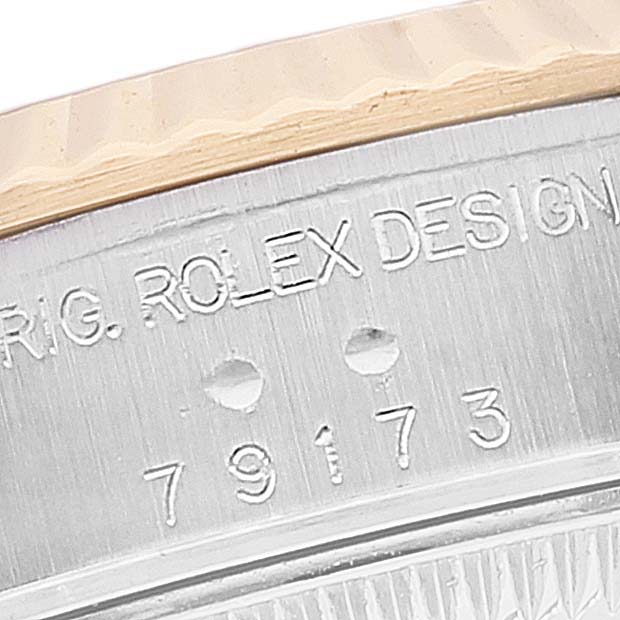 The image shows the engraved serial number and "ROLEX DESIGN" inscription on the side of the case of a Rolex Datejust 79173 Women's Steel and Gold (two tone) Silver Dial 79173 Women's Steel and Gold (two tone) Silver Dial watch.