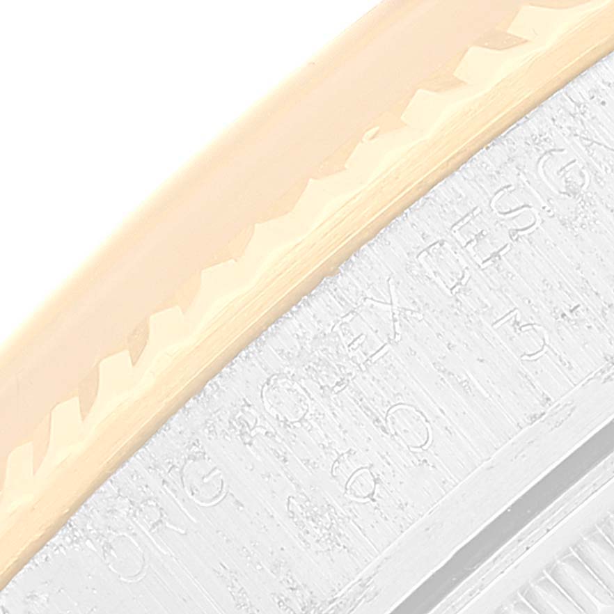 This image shows an extreme close-up of the bezel and engraved edge of a Vintage Collection model by Rolex.