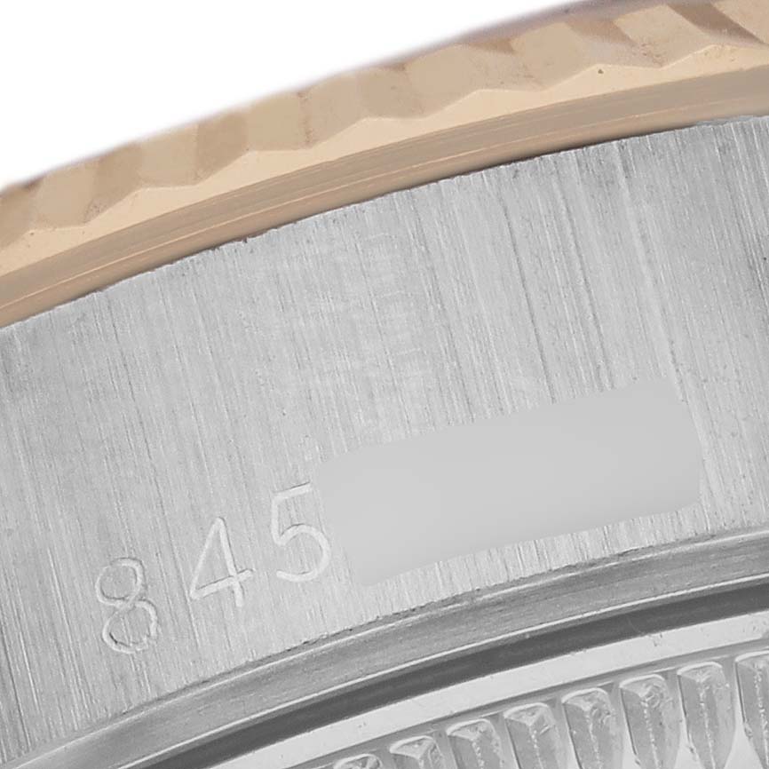 The image shows a close-up of the bezel and case edge of a Rolex Date 69173 Women
s Steel and Gold (two tone) White Dial 69173 Women
s Steel and Gold (two tone) White Dial watch.