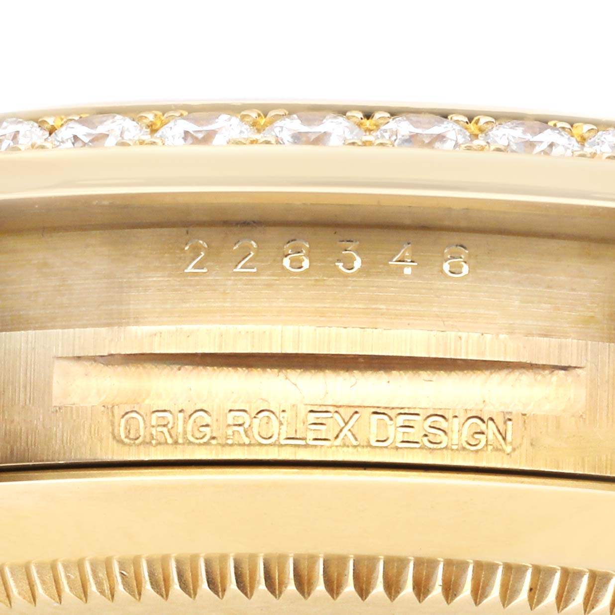 The image shows the side of the Rolex President 228348 Men's Yellow Gold Champagne Dial 228348 Men's Yellow Gold Champagne Dial model, displaying the engraved serial and design numbers.