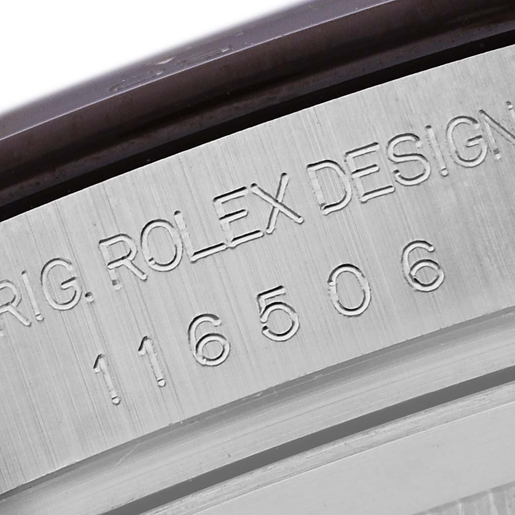 The image shows a close-up of the engraved bezel of a Rolex Daytona 116506 Men's Platinum Blue Dial 116506 Men's Platinum Blue Dial watch with its model number.