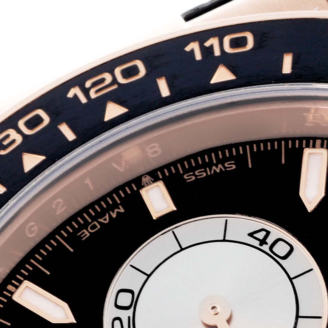The image shows a close-up of the Rolex Daytona 126515 Men's Rose Gold Black Dial 126515 Men's Rose Gold Black Dial watch bezel and part of the dial, highlighting the tachymetric scale.