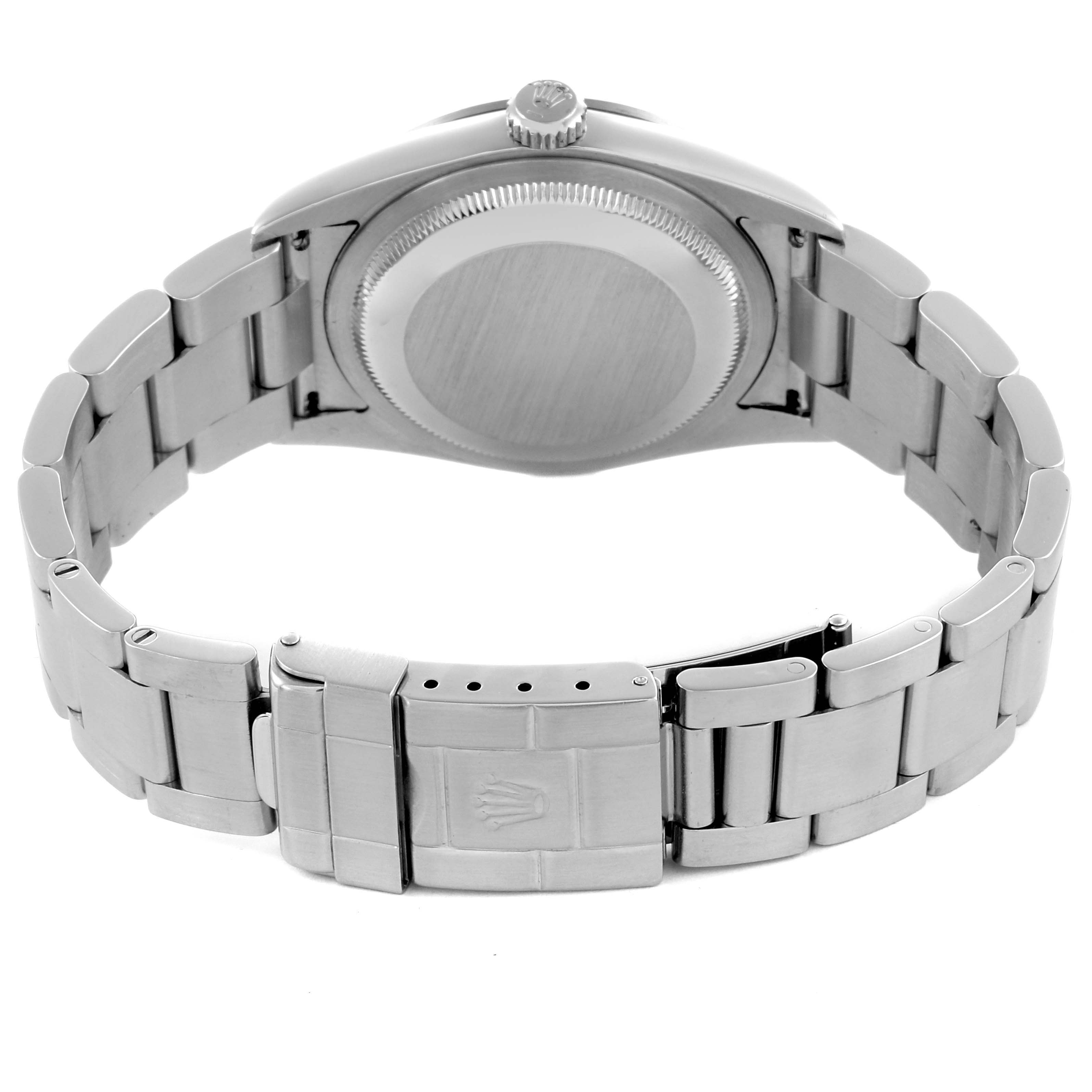 The Rolex Explorer 114270 Men
s Stainless Steel Black Dial 114270 Men
s Stainless Steel Black Dial watch is shown from the back, featuring the case back, bracelet, and clasp.