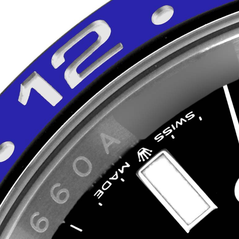 The image shows the bezel and part of the dial of a Rolex GMT-Master 126710BLNR Men
s Stainless Steel Black Dial 126710BLNR Men
s Stainless Steel Black Dial, featuring the "12" numeral and "SWISS MADE" text.
