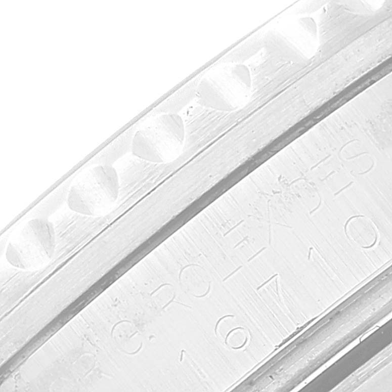 This close-up image of a Rolex GMT-Master 16710 Men
s Stainless Steel Black Dial 16710 Men
s Stainless Steel Black Dial watch shows the bezel and part of the engraved rehaut.