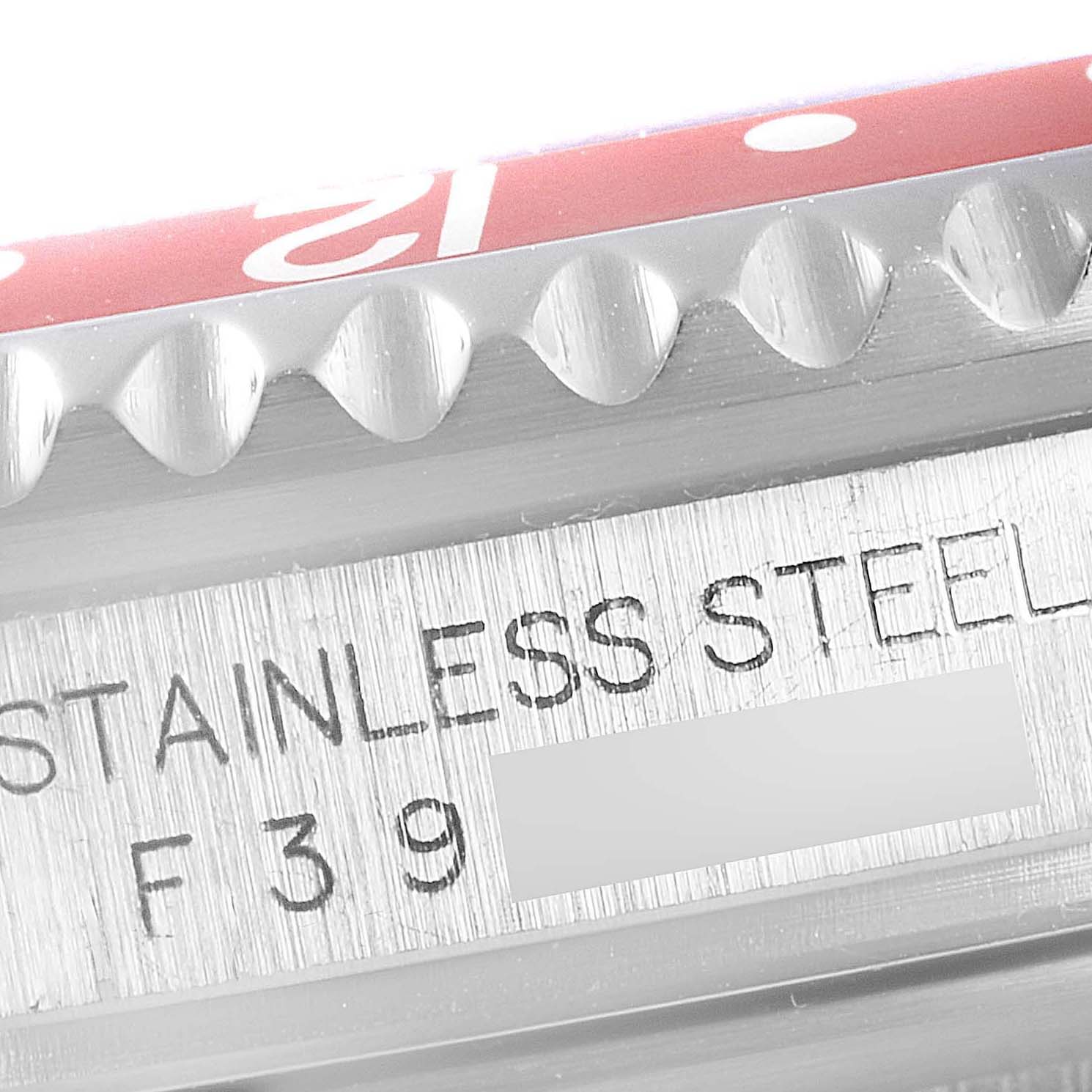 This is a close-up shot of the side of the Rolex GMT-Master 16710 Men's Stainless Steel Black Dial 16710 Men's Stainless Steel Black Dial watch, showing the stainless steel marking and bezel details.