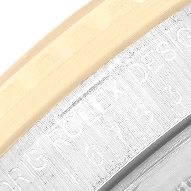 This close-up angle shows the engraved details on the outer edge of a Rolex Vintage Collection 16753 Men's Stainless Steel Brown Dial 16753 Men's Stainless Steel Brown Dial watch case.