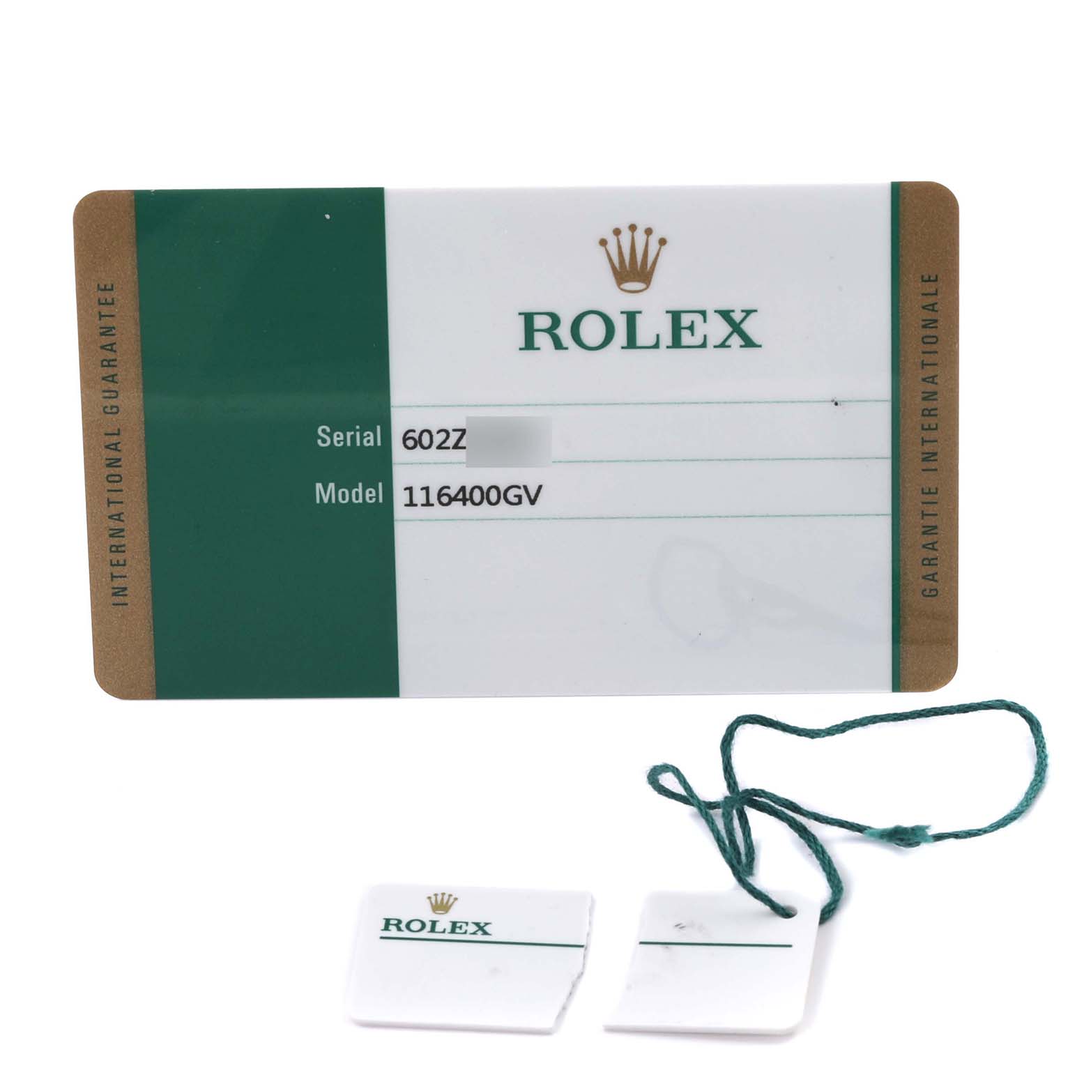 The image shows a Rolex Milgauss 116400GV Men's Stainless Steel Black Dial 116400GV Men's Stainless Steel Black Dial model warranty card and two tags with strings.