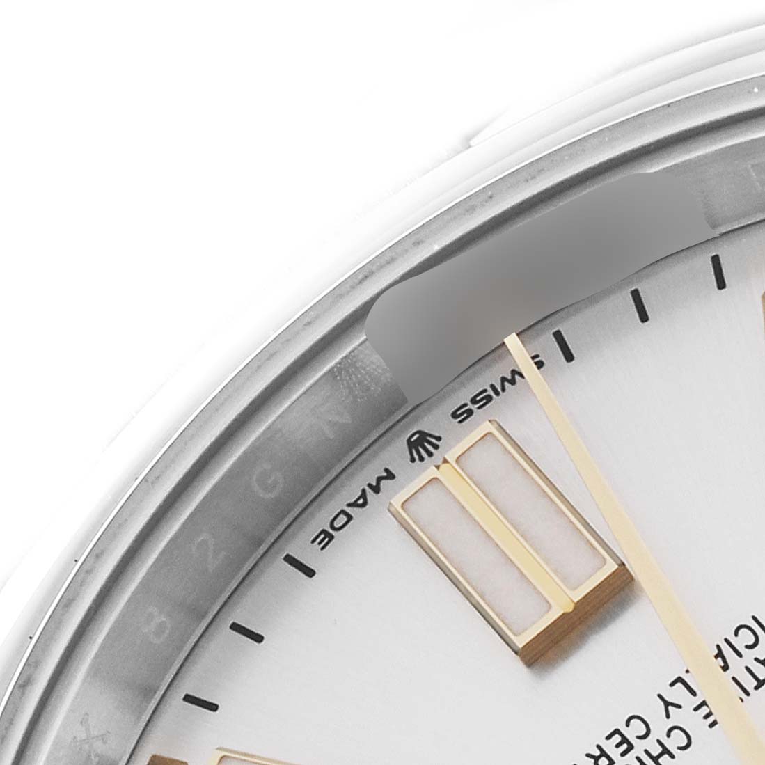 This image shows a close-up of the dial and part of the bezel of a Rolex Oyster Perpetual 124300 Men
s Stainless Steel Silver Dial 124300 Men
s Stainless Steel Silver Dial watch, highlighting the Swiss Made mark.