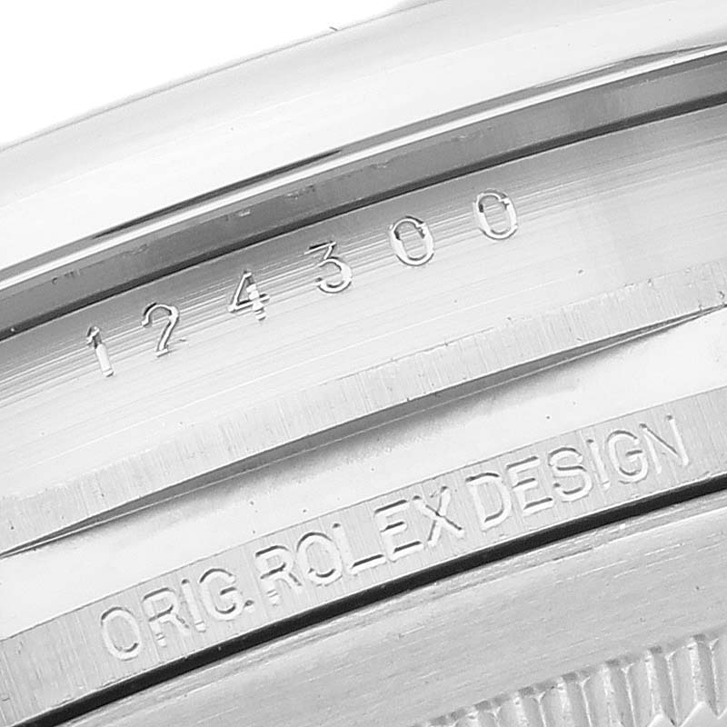 The image shows a close-up of the case back and edge of an Oyster Perpetual Rolex watch, featuring its model number and design engraving.