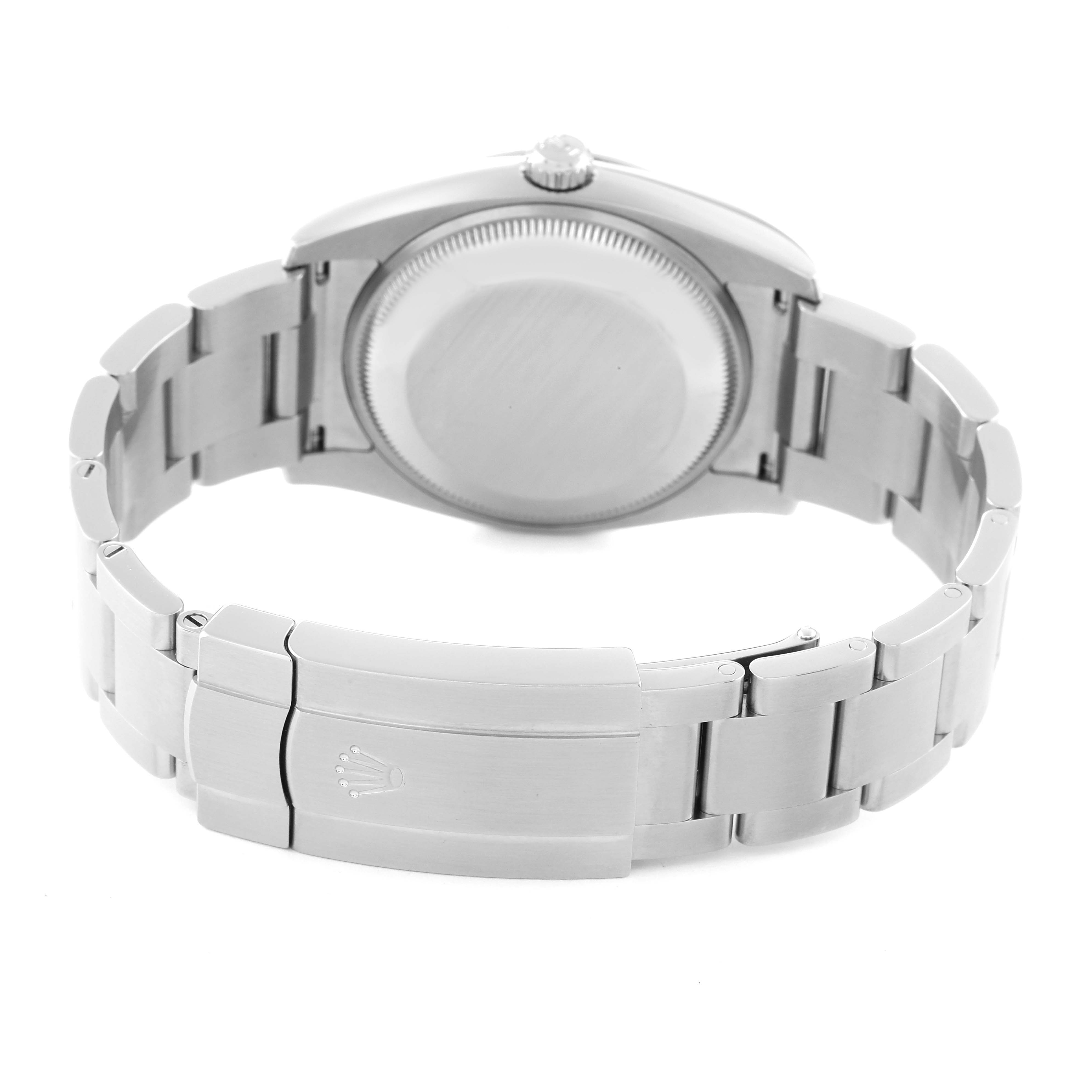 The image shows the back case and clasp of a Rolex Oyster Perpetual 114200 Men's Stainless Steel Black Dial 114200 Men's Stainless Steel Black Dial watch at an oblique angle.