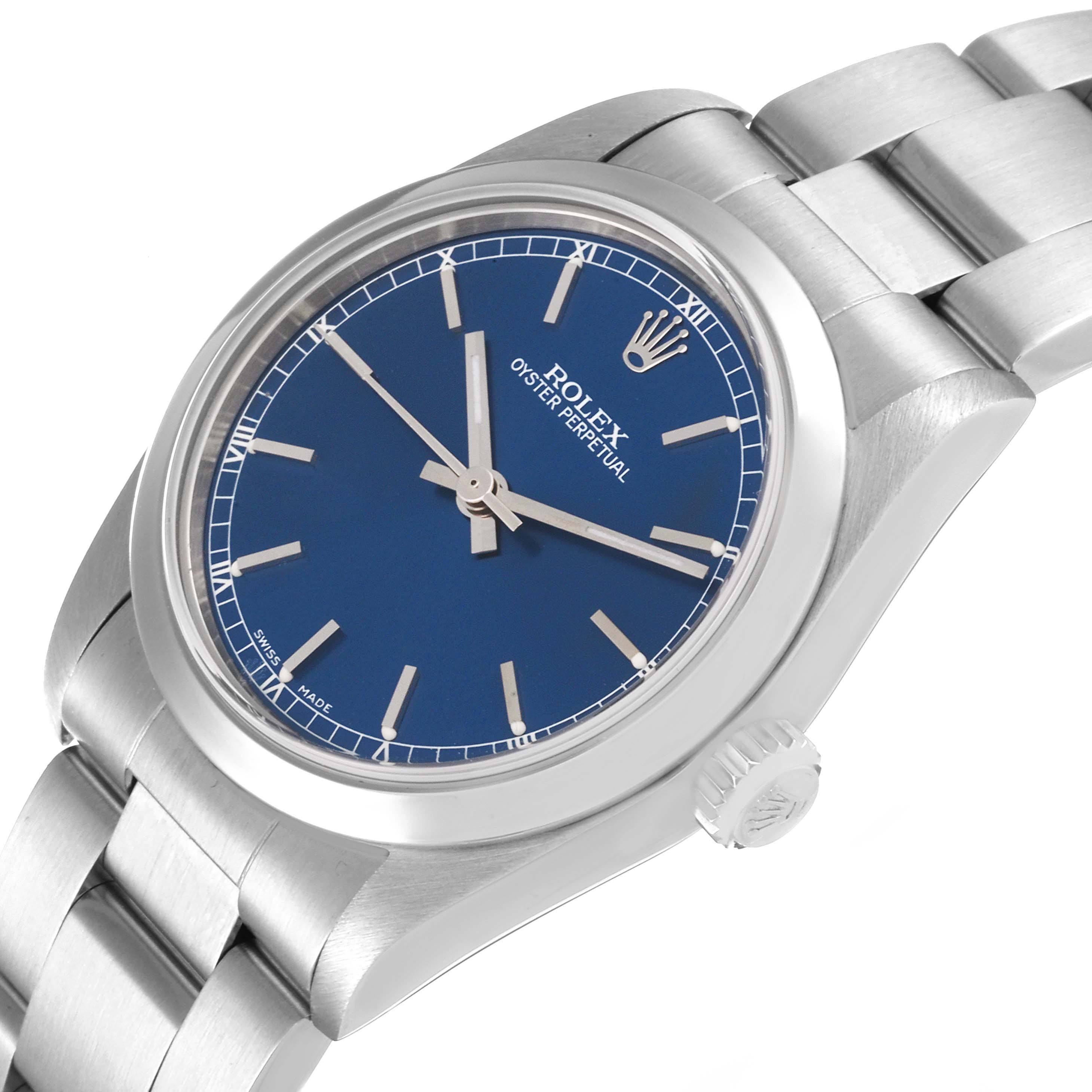 The image shows a Rolex Mid-Size 77080 Women
s Stainless Steel Blue Dial 77080 Women
s Stainless Steel Blue Dial Oyster Perpetual watch at a slight angle, highlighting its blue dial, case, and part of the bracelet.
