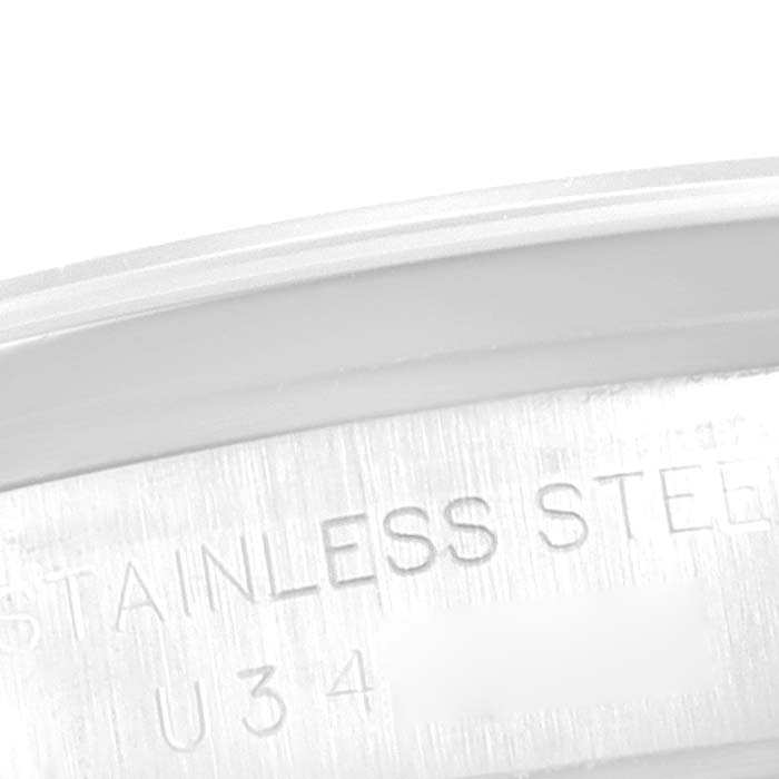 This image shows a close-up of the inner side of the case back of a Rolex Oyster Perpetual 67180 Women
s Stainless Steel Pink Dial 67180 Women
s Stainless Steel Pink Dial watch, revealing the stainless steel marking.