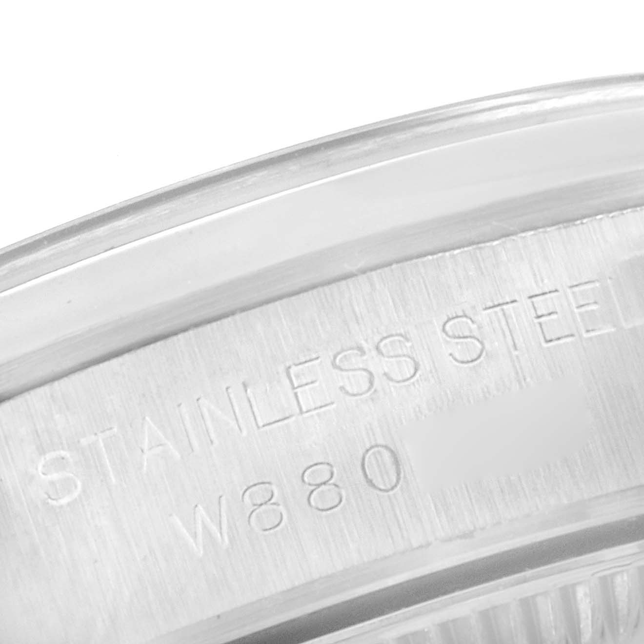 This close-up angle shows the "Stainless Steel" engraving on the case back edge of the Rolex Oyster Perpetual 67180 Women
s Stainless Steel Pink Dial 67180 Women
s Stainless Steel Pink Dial watch.
