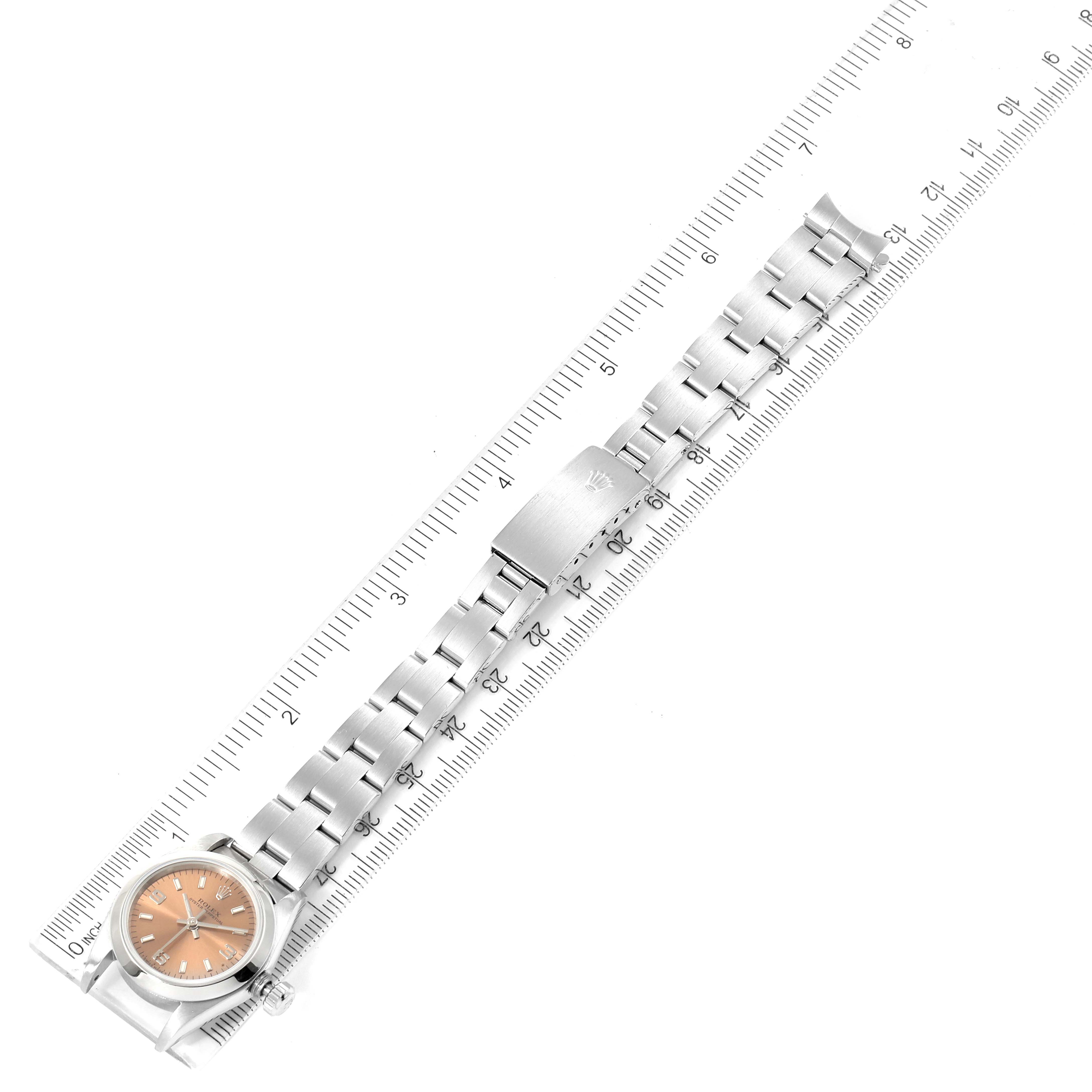 This image shows a top-down view of an Oyster Perpetual watch by Rolex, with a metal bracelet alongside a ruler.
