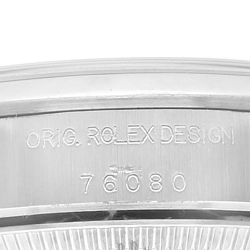 This image shows a close-up of the engraving on the case back of a Rolex Oyster Perpetual 76080 Women
s Stainless Steel Pink Dial 76080 Women
s Stainless Steel Pink Dial watch, displaying the model number 76080.