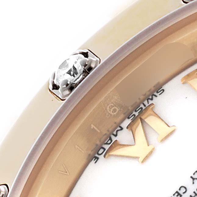 The image shows a close-up of the Rolex Pearlmaster 80318 Women's Yellow Gold White Dial 80318 Women's Yellow Gold White Dial watch's bezel and a portion of the dial with a diamond accent.