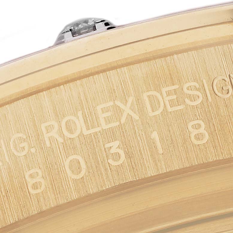 The image shows a close-up of the side engraving on a Rolex Pearlmaster 80318 Women's Yellow Gold White Dial 80318 Women's Yellow Gold White Dial watch.