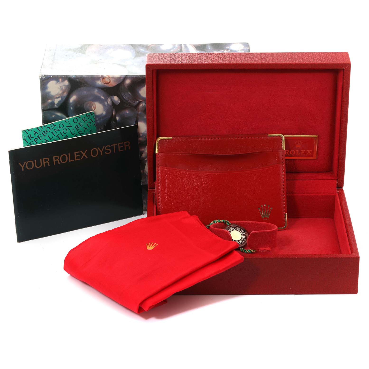 This image shows the packaging and accessories for a Rolex President 69138 Women
s Yellow Gold Champagne Dial 69138 Women
s Yellow Gold Champagne Dial model, including box, booklet, wallet, and cleaning cloth.