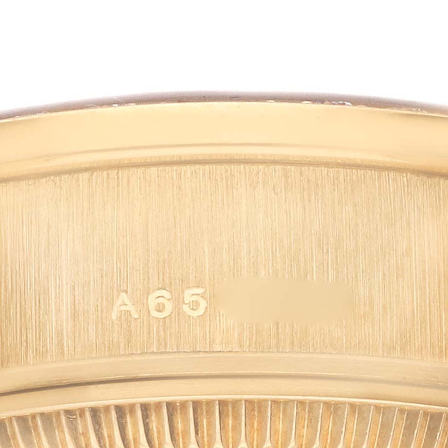 The image shows the side edge of a Rolex President 79088 Women's Yellow Gold Champagne Dial 79088 Women's Yellow Gold Champagne Dial watch, highlighting part of the bezel and engraved details.