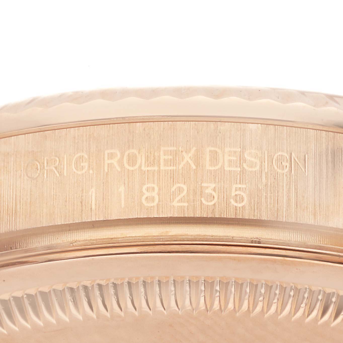 The image shows a close-up side view of the Rolex President 118235 Men's Rose Gold Pink Dial 118235 Men's Rose Gold Pink Dial model, highlighting the engraved bezel with model number 118235.