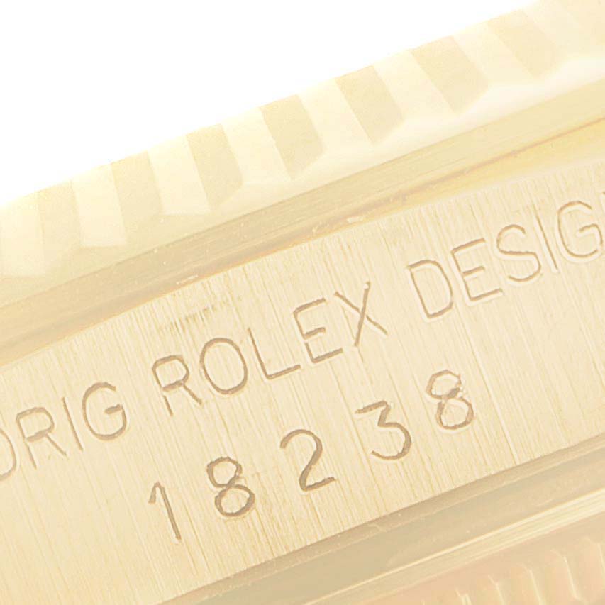 This image shows a close-up of the Rolex President 18238 Men
s Yellow Gold Champagne Dial 18238 Men
s Yellow Gold Champagne Dial model
s watch case, highlighting the engraved model number 18238.