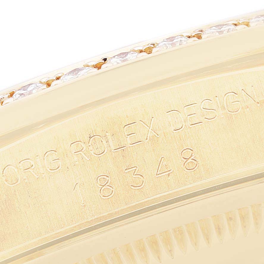 The close-up shows the side of the bezel and part of the case of a Rolex President 18348 Men
s Yellow Gold Champagne Dial 18348 Men
s Yellow Gold Champagne Dial model watch with engravings.