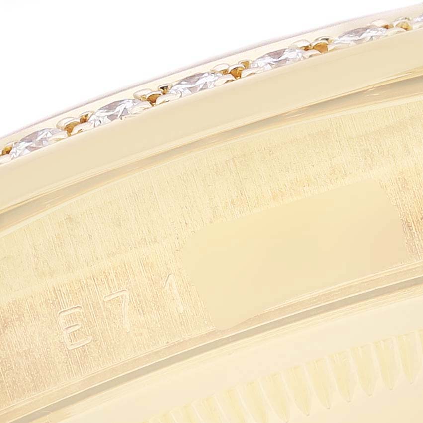 This close-up image shows the bezel and part of the case back of a Rolex President 18348 Men
s Yellow Gold Champagne Dial 18348 Men
s Yellow Gold Champagne Dial model, highlighting the diamond-set bezel and some engraved details.
