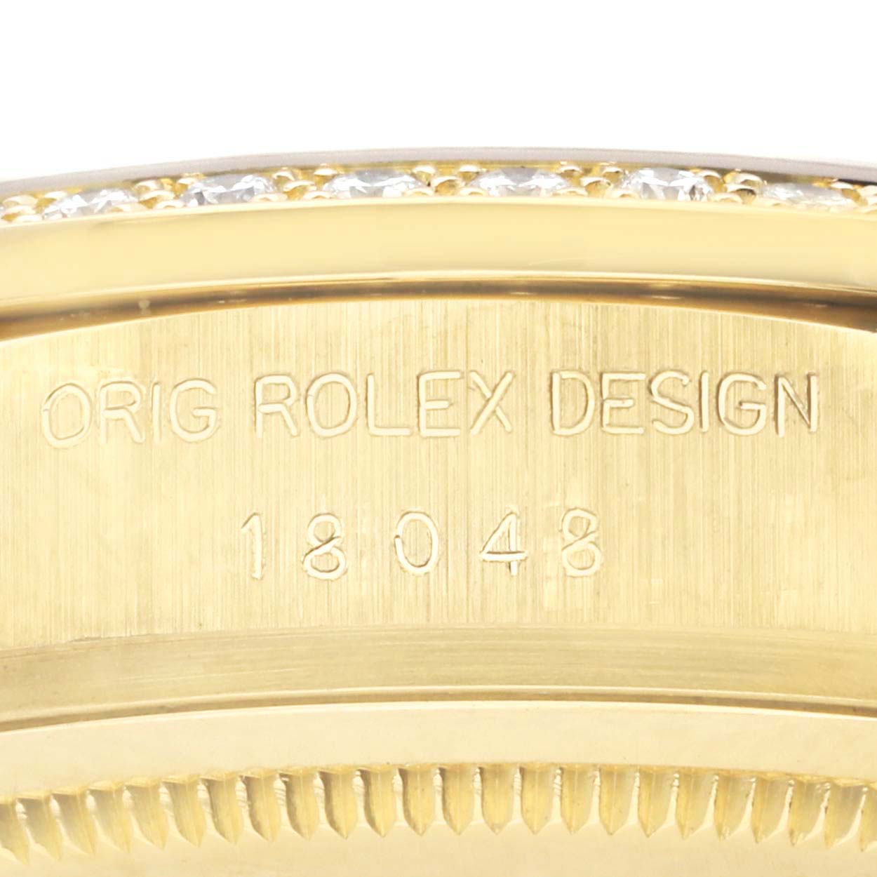 This image shows the side engraving and part of the bezel of a Rolex President 18048 Men's Yellow Gold Champagne Dial 18048 Men's Yellow Gold Champagne Dial watch, featuring its model number.