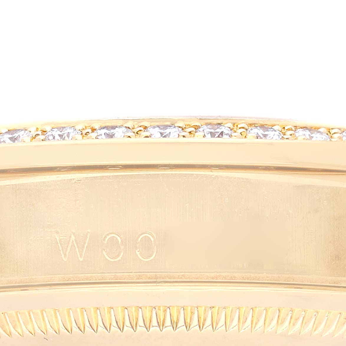 The image shows a close-up view of the bezel and part of the case of a Rolex President 18388 Men
s Yellow Gold Champagne Dial 18388 Men
s Yellow Gold Champagne Dial model watch, highlighting its gold finish and embedded diamonds.