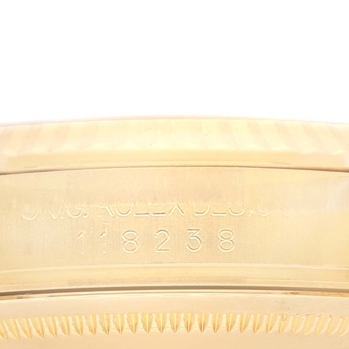 This image shows a close-up of the side of a Rolex President 118238 Men
s Yellow Gold White Dial 118238 Men
s Yellow Gold White Dial model, highlighting the casing with engraved text.