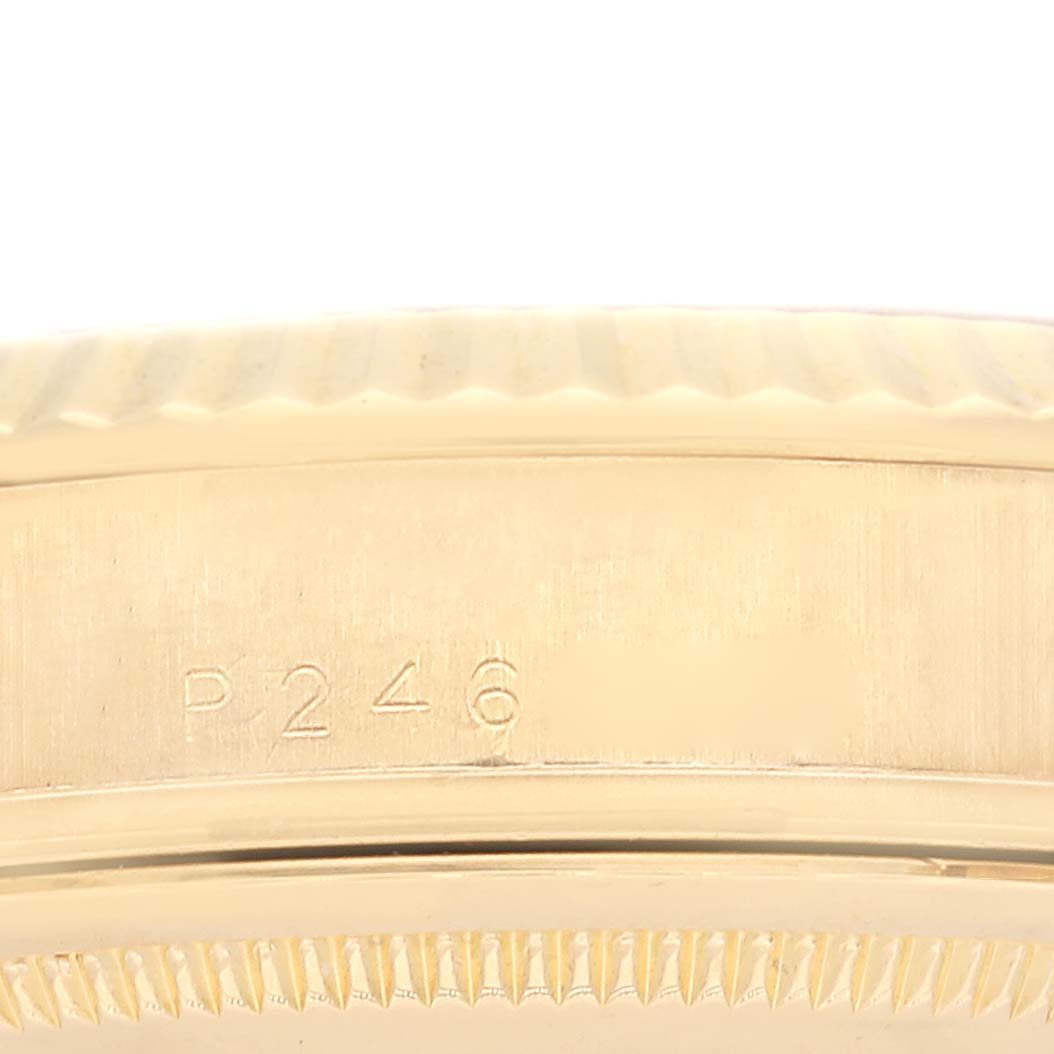 The image shows the side view of the bezel and case of a Rolex President 118238 Men
s Yellow Gold White Dial 118238 Men
s Yellow Gold White Dial model watch, highlighting the engraved serial number "P246."