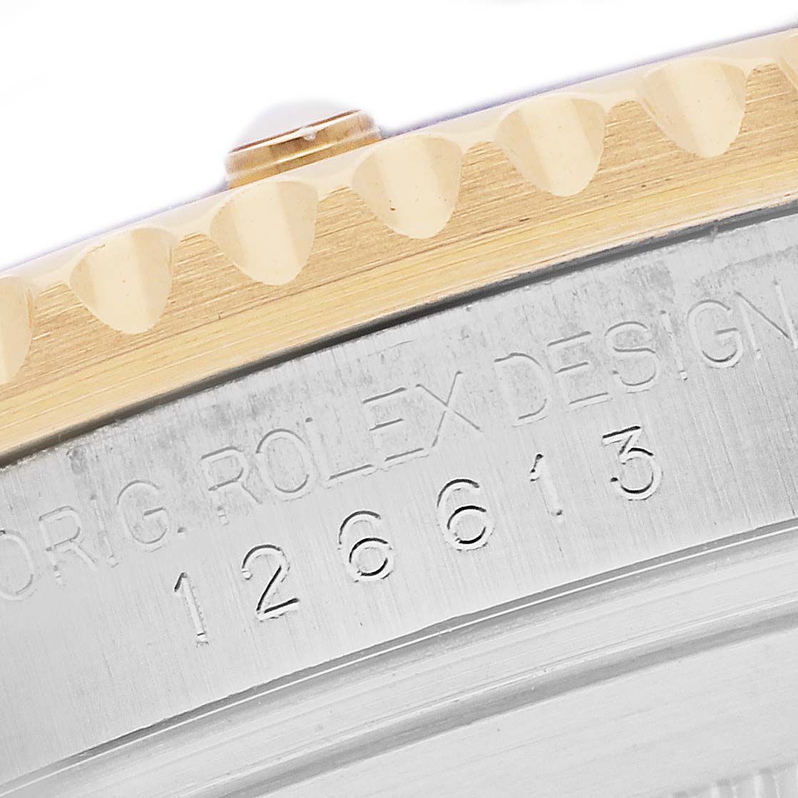 The image shows the side of a Rolex Submariner 126613LB Men's Steel and Gold (two tone) Blue Dial 126613LB Men's Steel and Gold (two tone) Blue Dial, highlighting the serial number and part of the bezel.