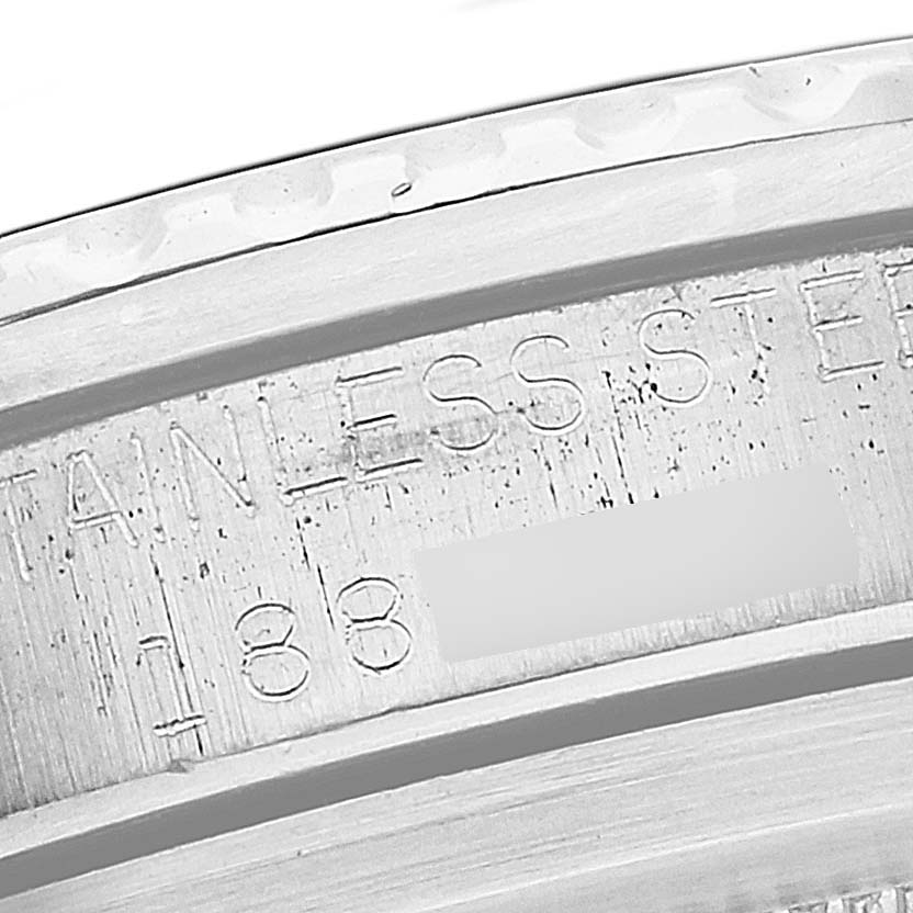 Close-up image showing the engraved serial number and "STAINLESS STEEL" text on a Rolex Vintage Collection 5512 Men's Stainless Steel Black Dial 5512 Men's Stainless Steel Black Dial watch case.