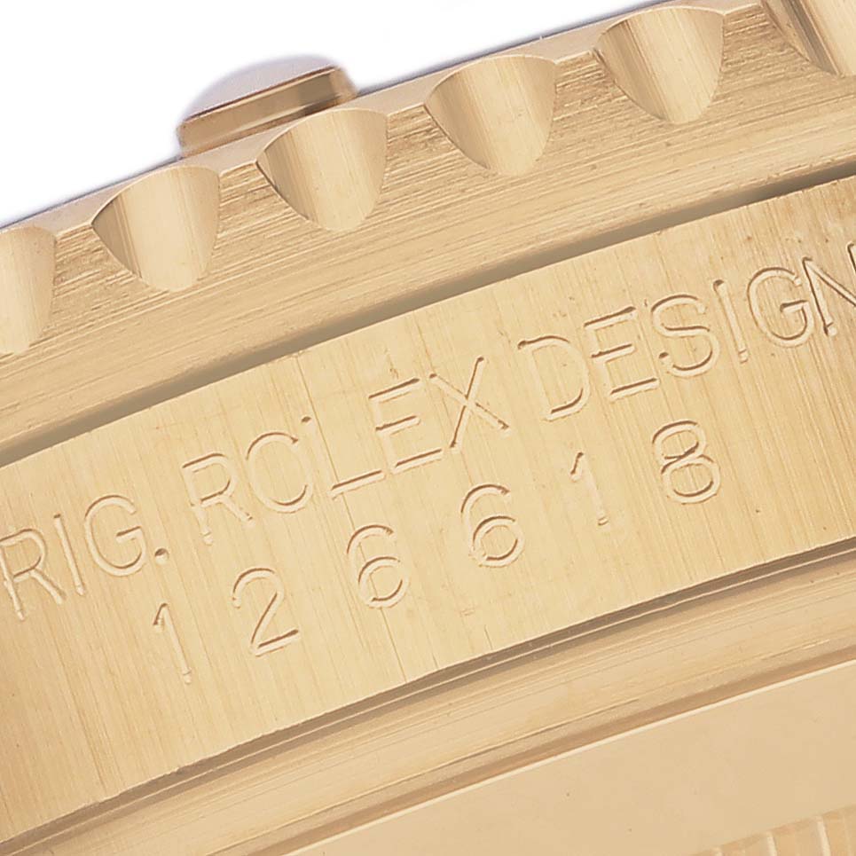 The image shows a close-up of the bezel and part of the engraved case of a Rolex Submariner 126618LB Men's Yellow Gold Blue Dial 126618LB Men's Yellow Gold Blue Dial watch.