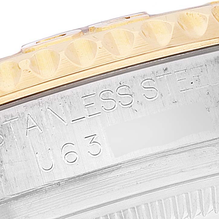 The image shows a close-up of the Rolex Yacht-Master 68623 Men
s Steel and Gold (two tone) White Dial 68623 Men
s Steel and Gold (two tone) White Dial watch
s bezel and part of the case with engraved text.