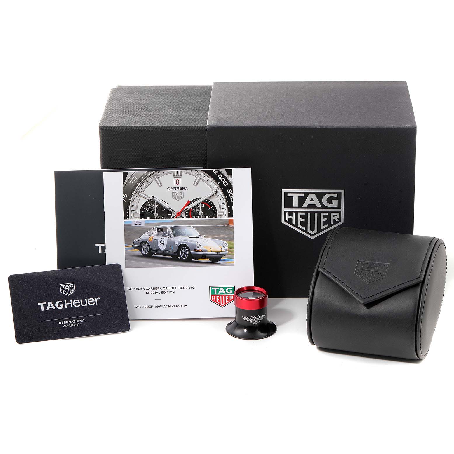 The image shows the Tag Heuer Carrera CBN2A1D.BA0643 Men's Stainless Steel Silver Dial CBN2A1D.BA0643 Men's Stainless Steel Silver Dial watch accessories, including a box, warranty card, manual, pouch, and loupe.