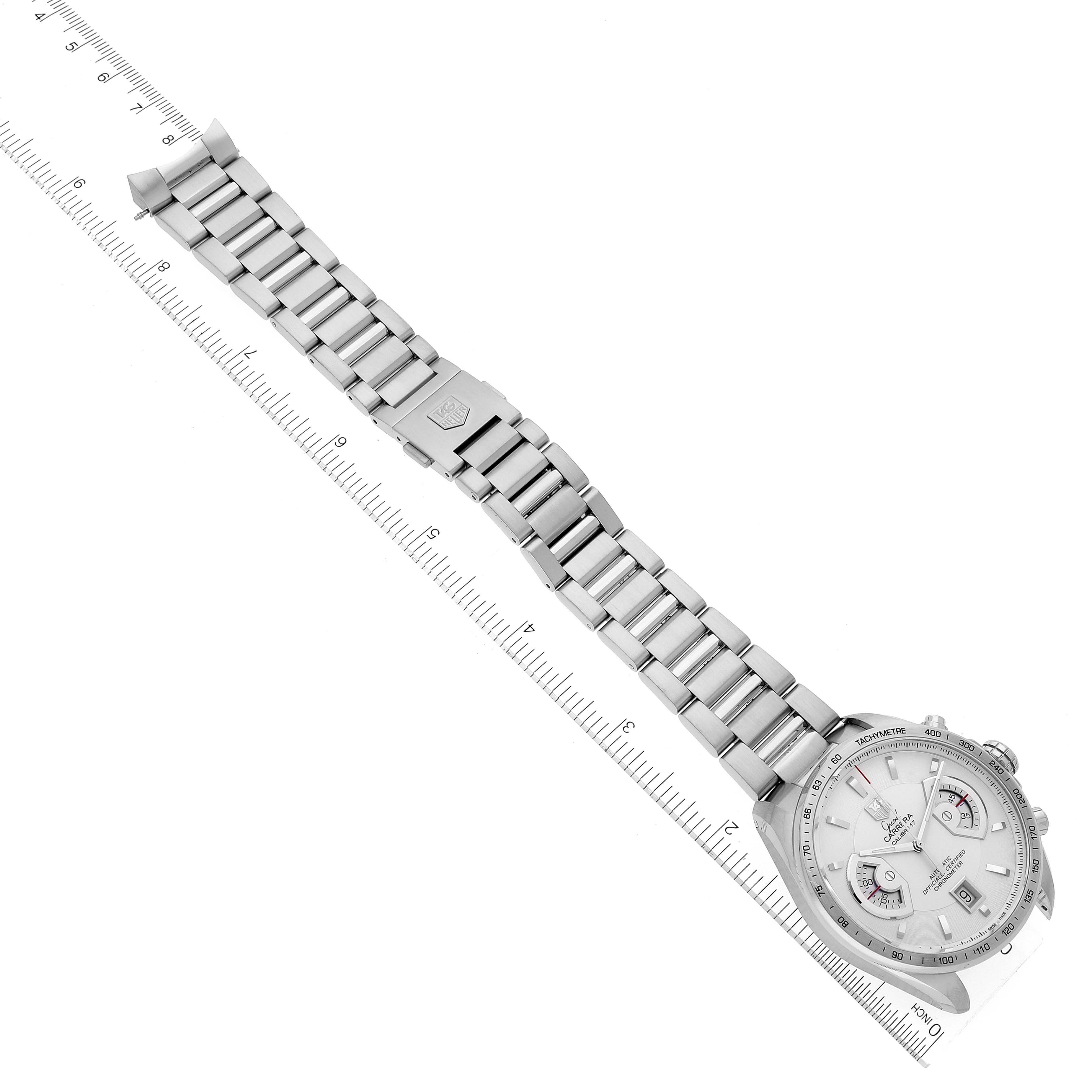 The image shows a top-down view of a Tag Heuer Carrera CAV511B.BA0902 Men
s Stainless Steel Silver Dial CAV511B.BA0902 Men
s Stainless Steel Silver Dial watch, including the dial and full metal bracelet, placed on top of a ruler.