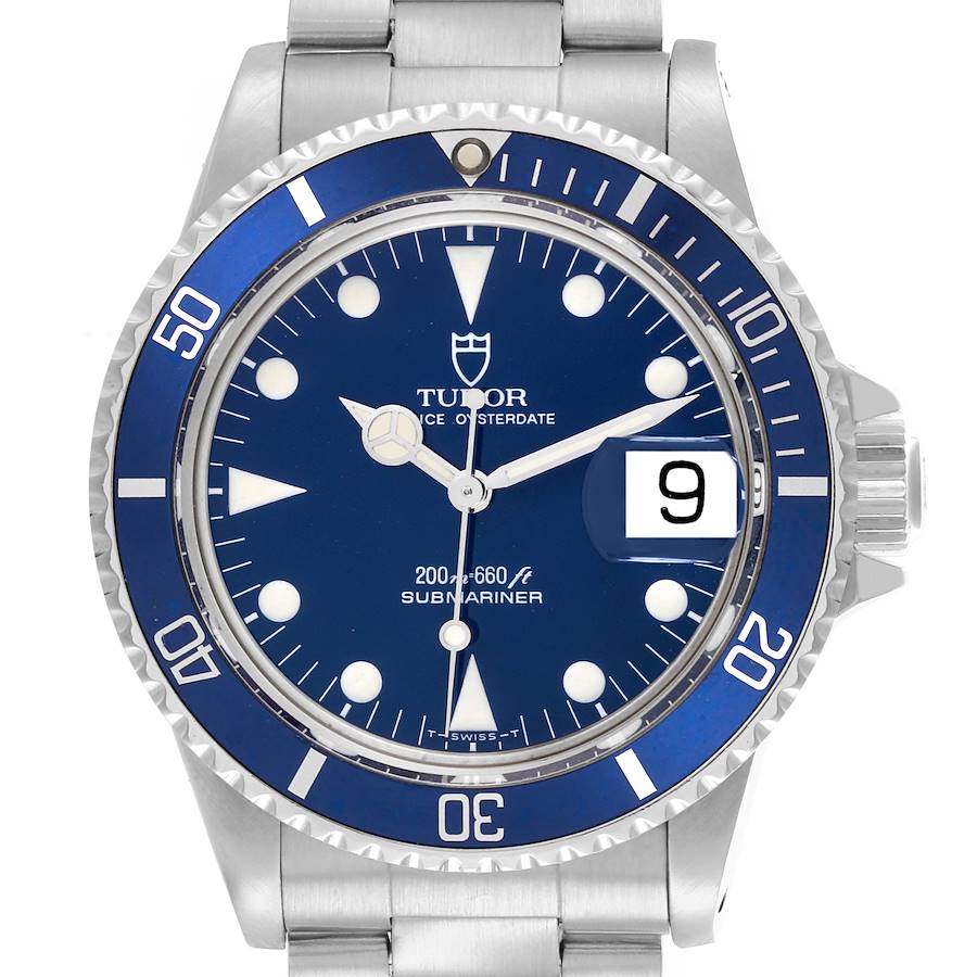 The Tudor Submariner is shown from the front, displaying its blue dial, bezel, and date window.