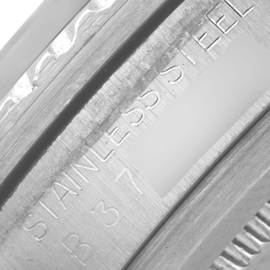 The image shows a close-up of the case engraving and bezel of the Tudor Submariner 79090 Men's Stainless Steel Blue Dial 79090 Men's Stainless Steel Blue Dial, highlighting "STAINLESS STEEL."