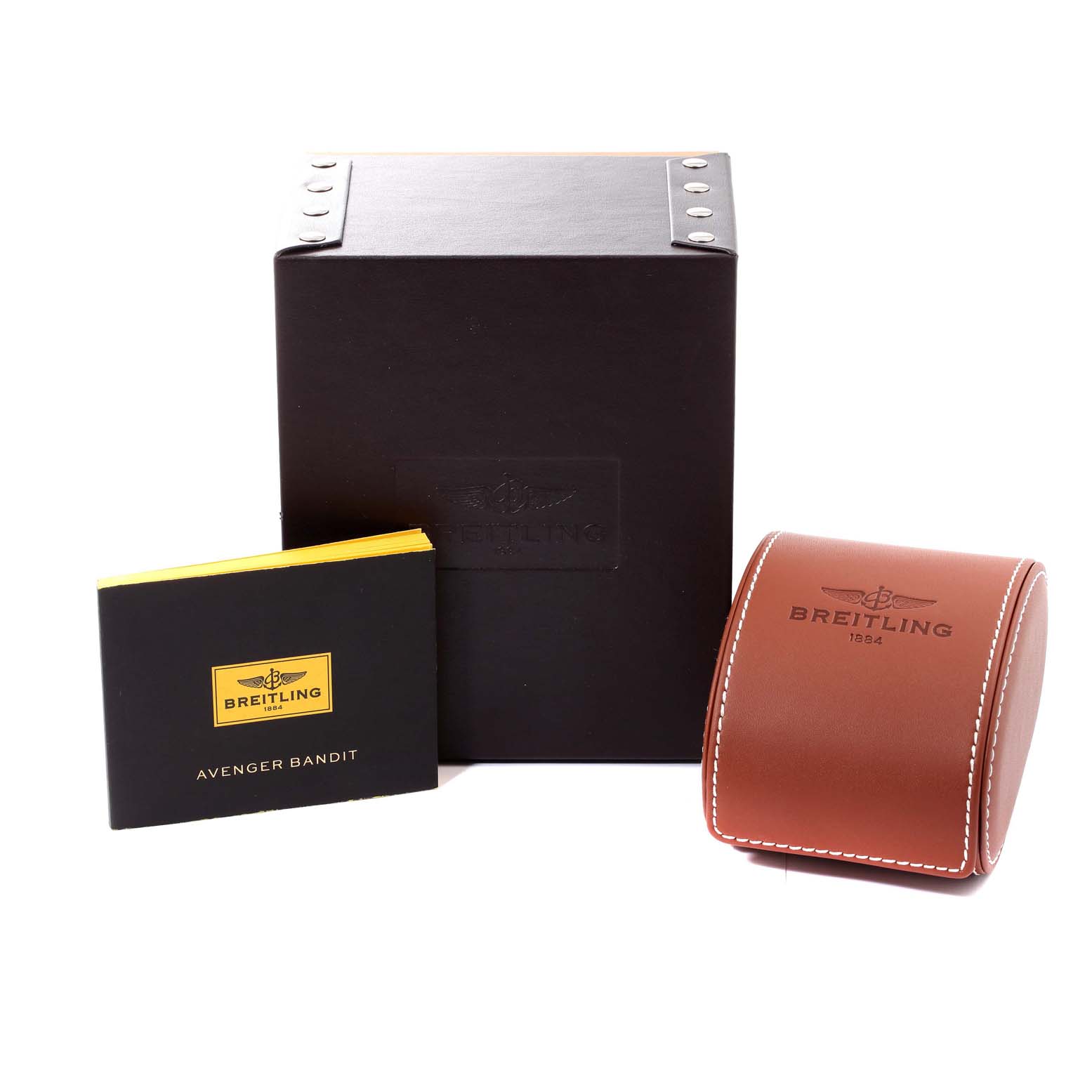 The image shows an Avenger watch box, a manual, and a leather case by Breitling.