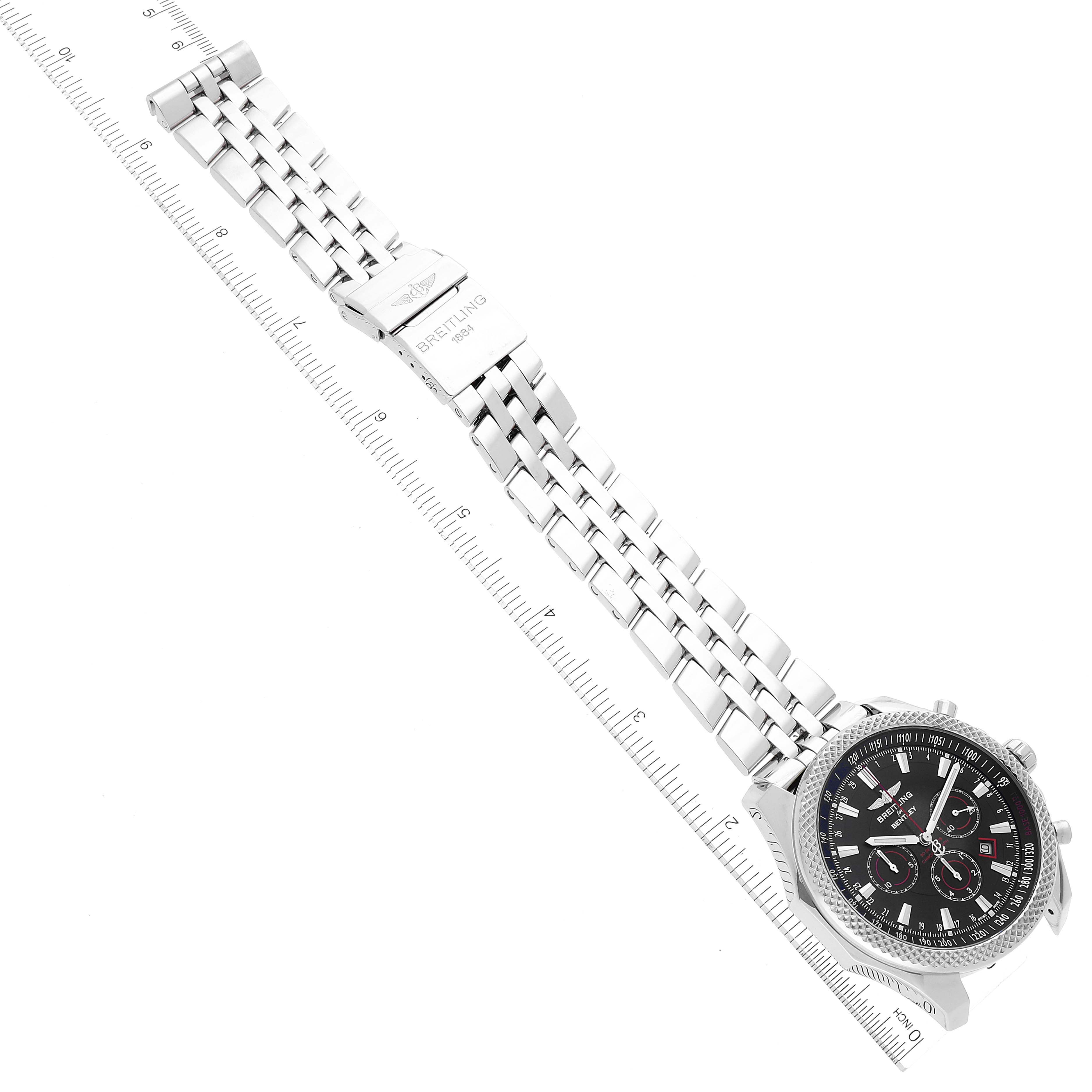 The image shows a top view of a Breitling Bentley A25368 Men's Stainless Steel Black Dial A25368 Men's Stainless Steel Black Dial model watch with a metal bracelet laid next to a ruler.