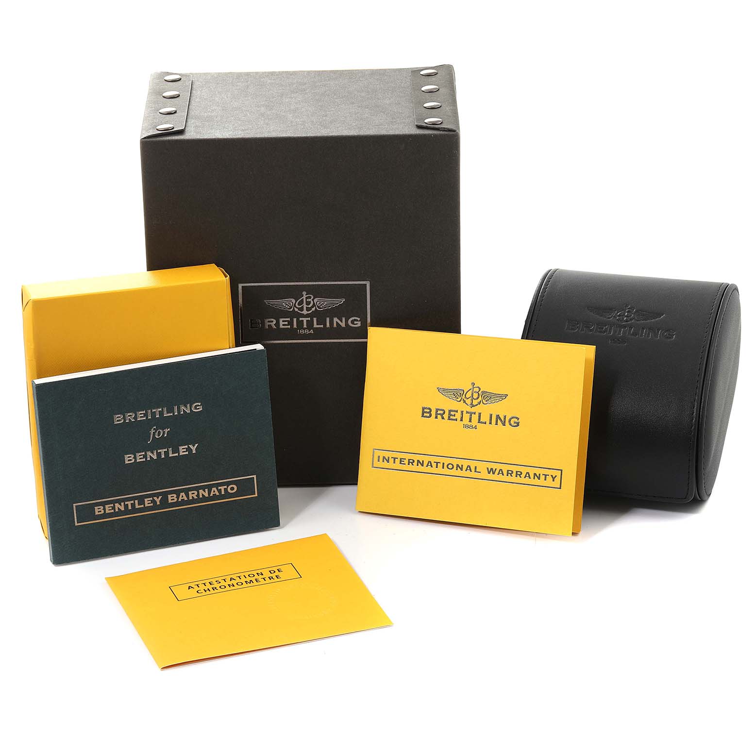 The image shows the packaging and documentation for the Bentley model by Breitling, including the box, warranty, and manuals.