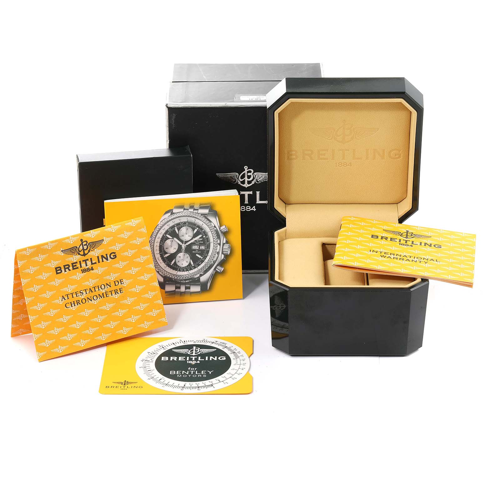 The image shows the packaging, warranty cards, and official documents for the Bentley model by Breitling.